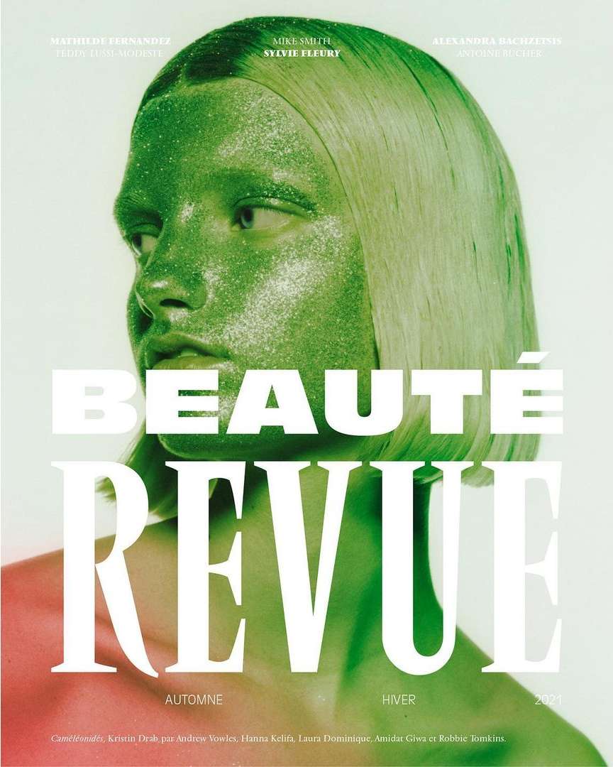 Magazine cover featuring a woman with glittery green skin and hair, against a bright background with stylized text overlay.