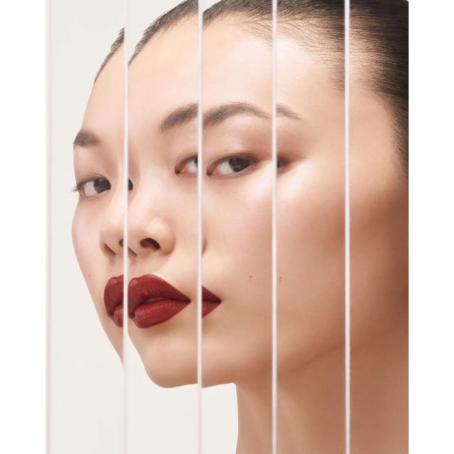 Close-up of an East Asian adult woman with red lipstick, smooth skin and a beauty shot with vertical divisions in the frame.