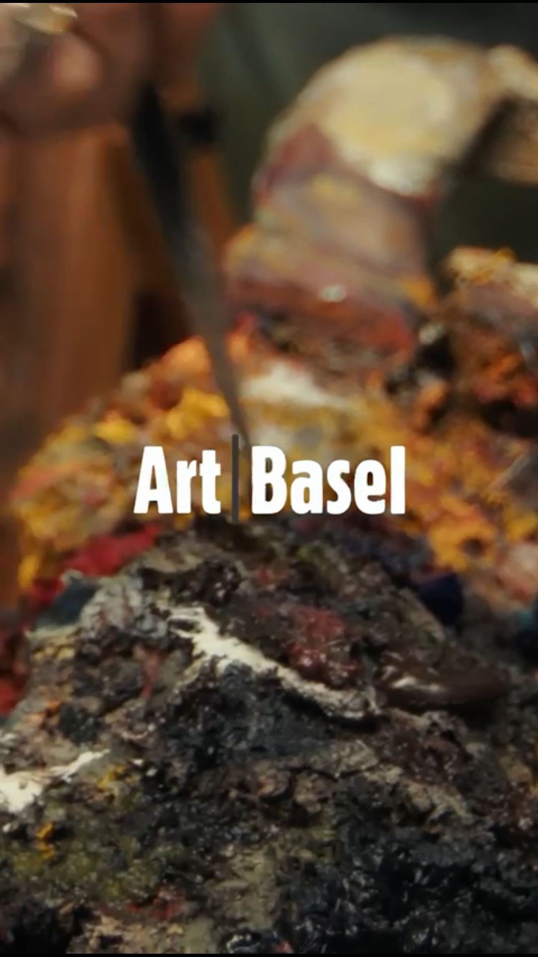 Close-up shot featuring a knife in a multicolored art palette with white "Art Basel" text overlayed, showcasing creative expression.