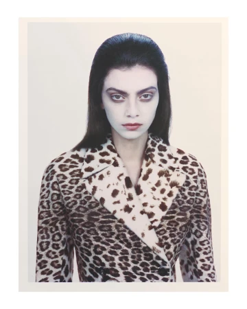 Portrait of a woman wearing a leopard print jacket against a plain light background by Andy Harrington