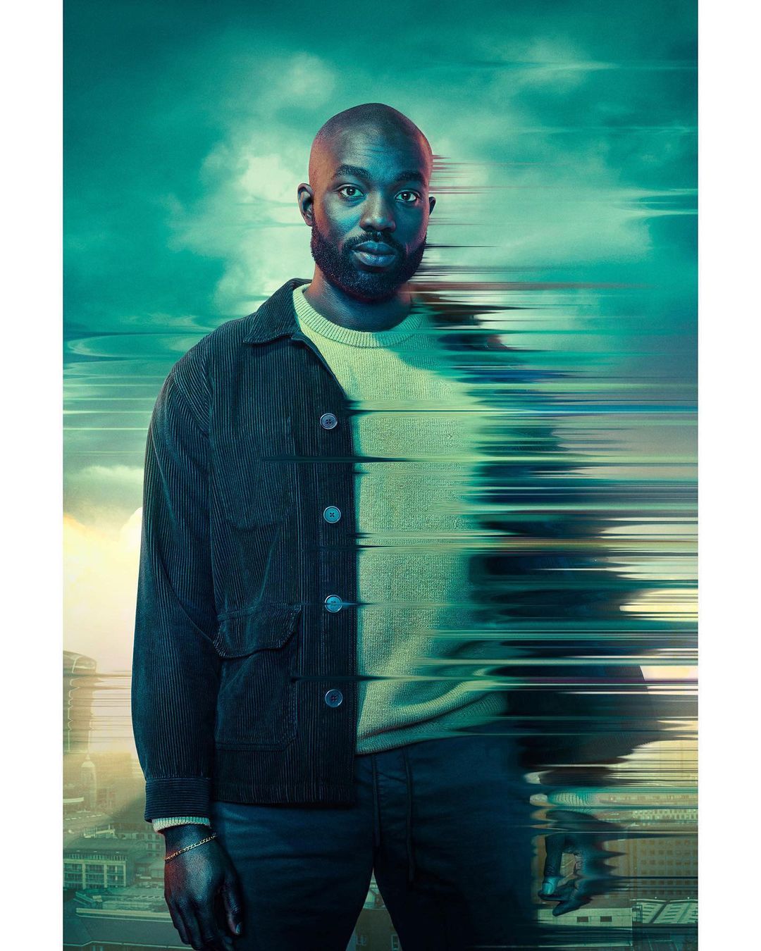 Portrait of a Black man with a beard wearing a corduroy jacket and sweater with digital glitch effect against a city skyline backdrop.