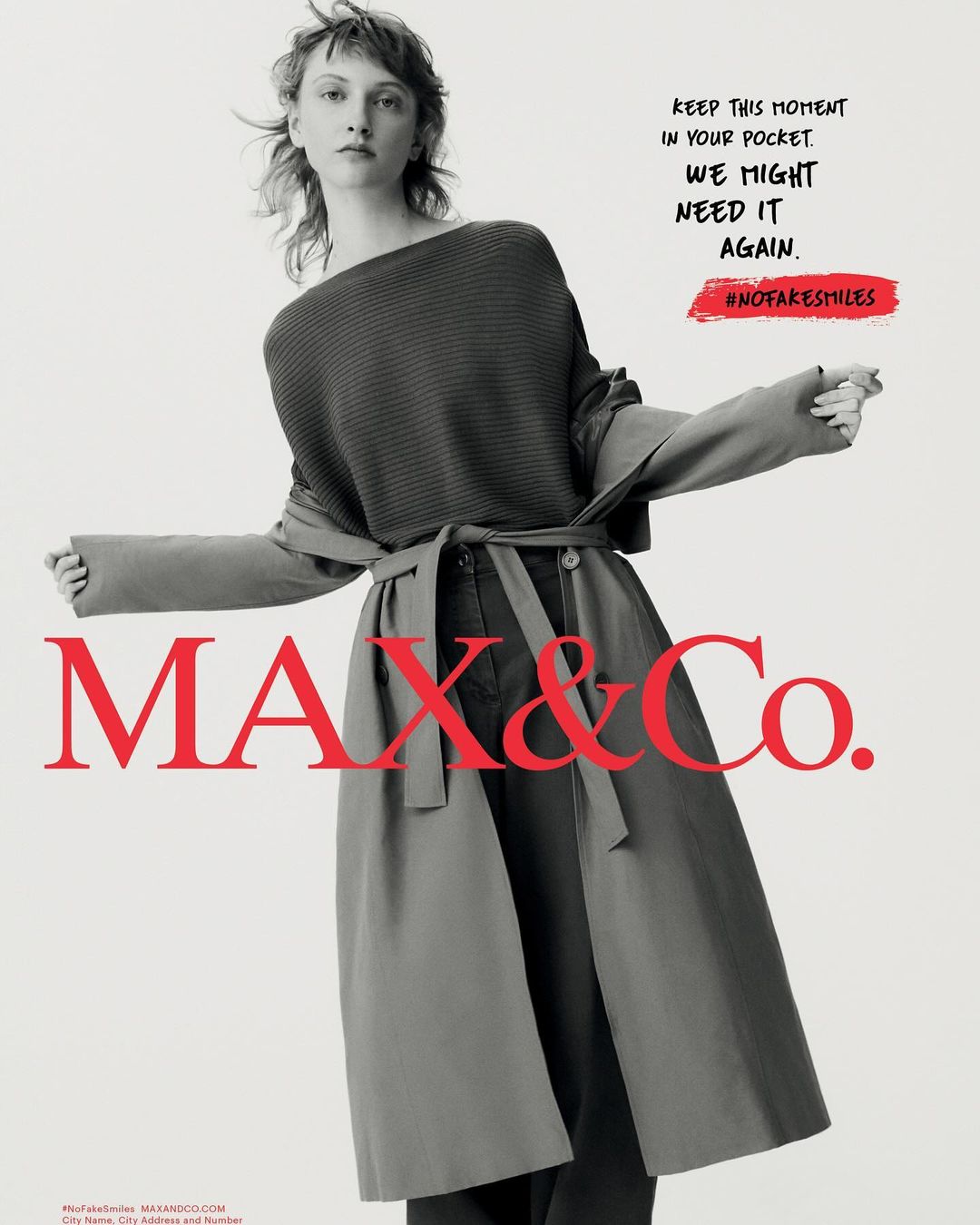 Fashion advertisement featuring a woman wearing a grey belted trench coat and matching sweater, with the MAX&Co. logo.