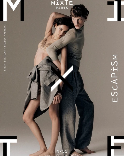 Fashion magazine cover featuring two androgynous models in stylish clothing, set against a neutral backdrop with bold typography and a minimalist aesthetic.