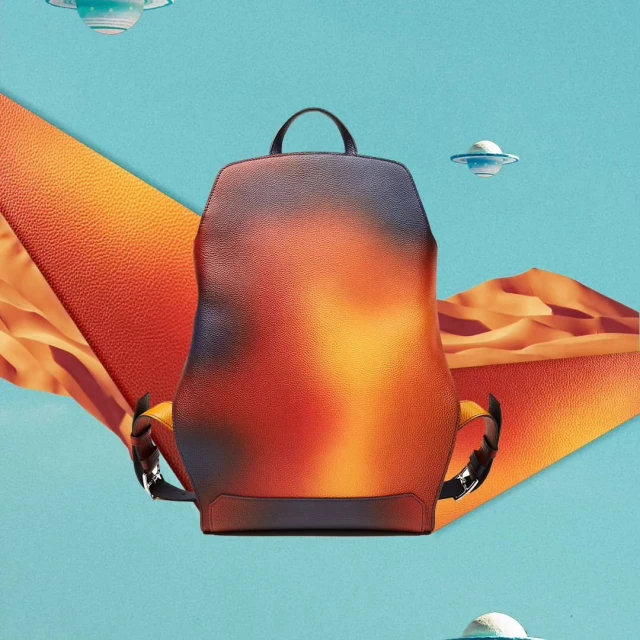 Fashionable backpack with a gradient color scheme, set against a surreal backdrop of desert landscape and geometric shapes.