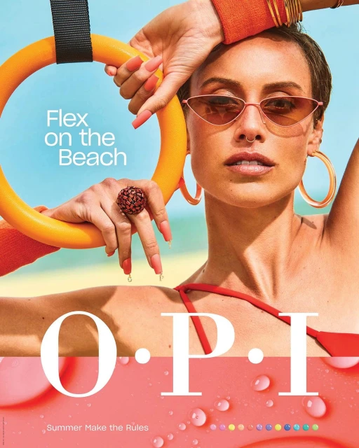 A fashionable woman with a sleek bob poses with an exercise ring in a beauty advertisement against a bright blue sky backdrop.