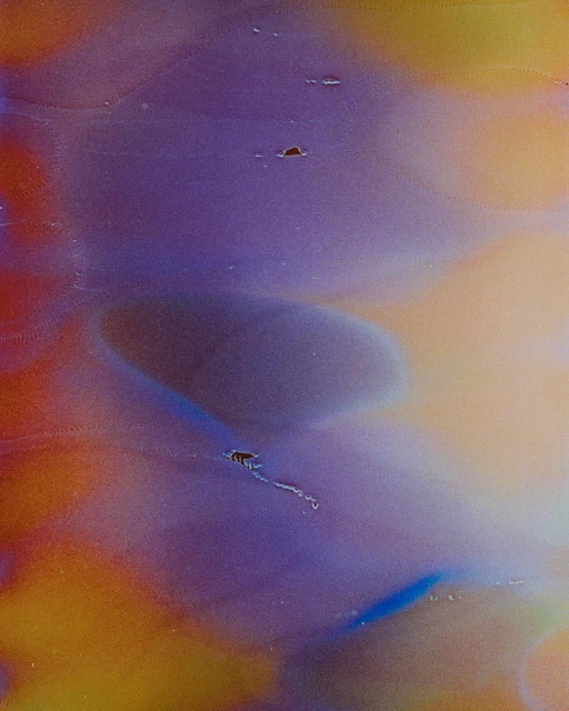 Abstract art featuring a fluid blend of purple, yellow, orange, and blue hues, creating a smooth and colourful texture. 