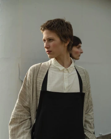Portrait of two women wearing a striped cardigan and black apron by photographer Anna Rosa Krau in Paris