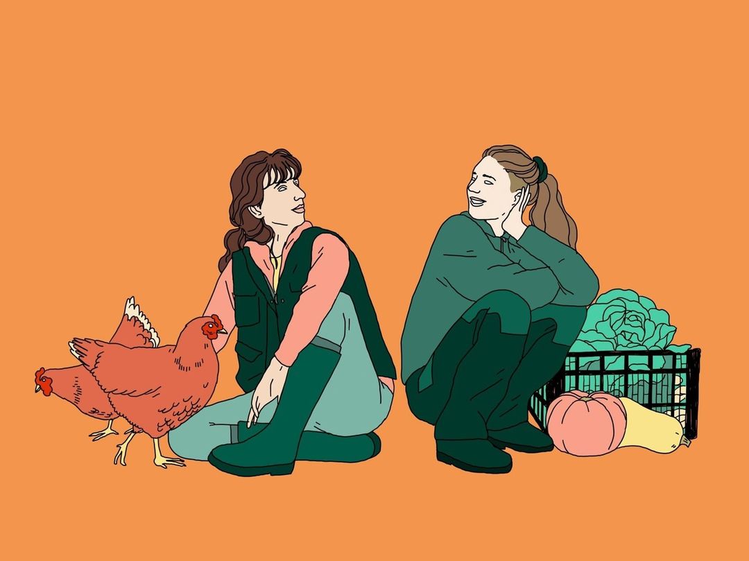 Two women in work clothes sit among crops and chickens in an illustration against a bright orange background on a sunny day.