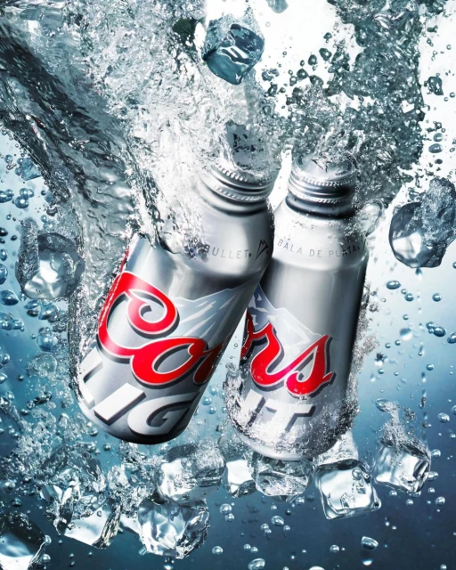 Two Coors Light aluminum beer bottles are partially submerged among ice cubes, water droplets, and splashes against a gradient background.