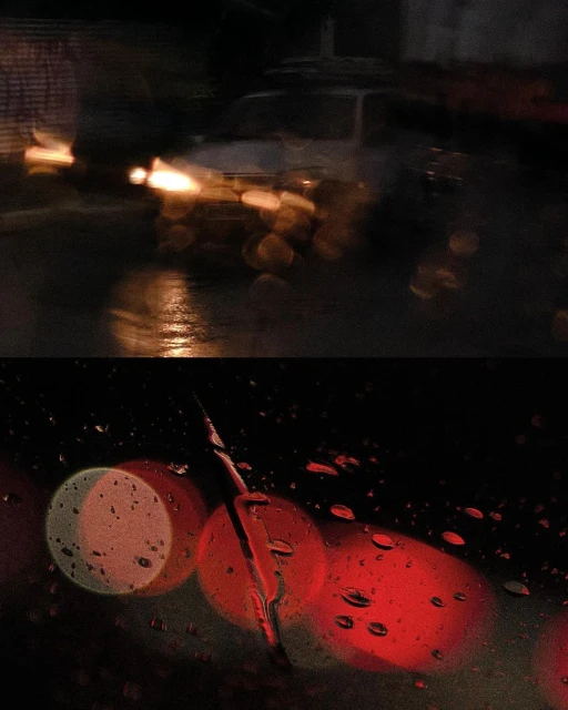 Rainy night cityscape featuring car headlights reflecting on wet streets. Dark ambiance with blurred lights and rain droplets on glass.