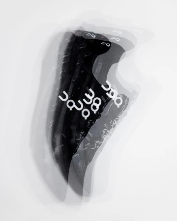 Multiple exposure photograph of a black athletic shoe with white branding against a plain white background