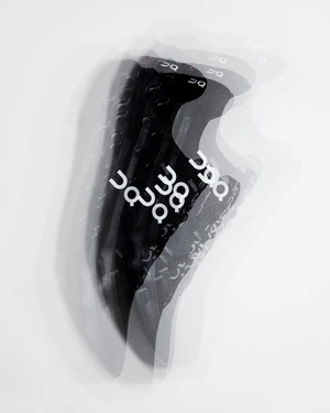 Multiple exposure photograph of a black athletic shoe with white branding against a plain white background