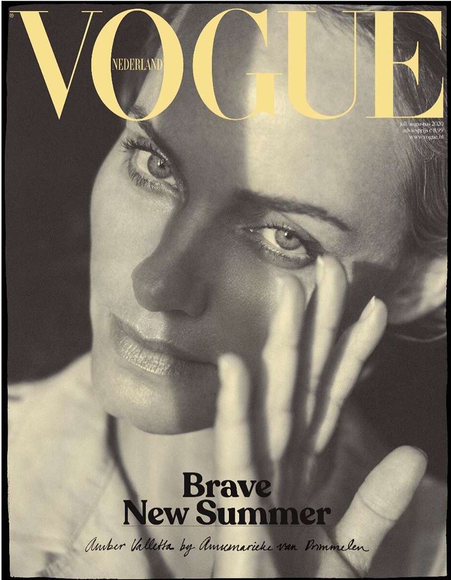 Fashion magazine cover featuring a close-up portrait of a woman with her hand near her face, contrasted with dark shadows and bright highlights.