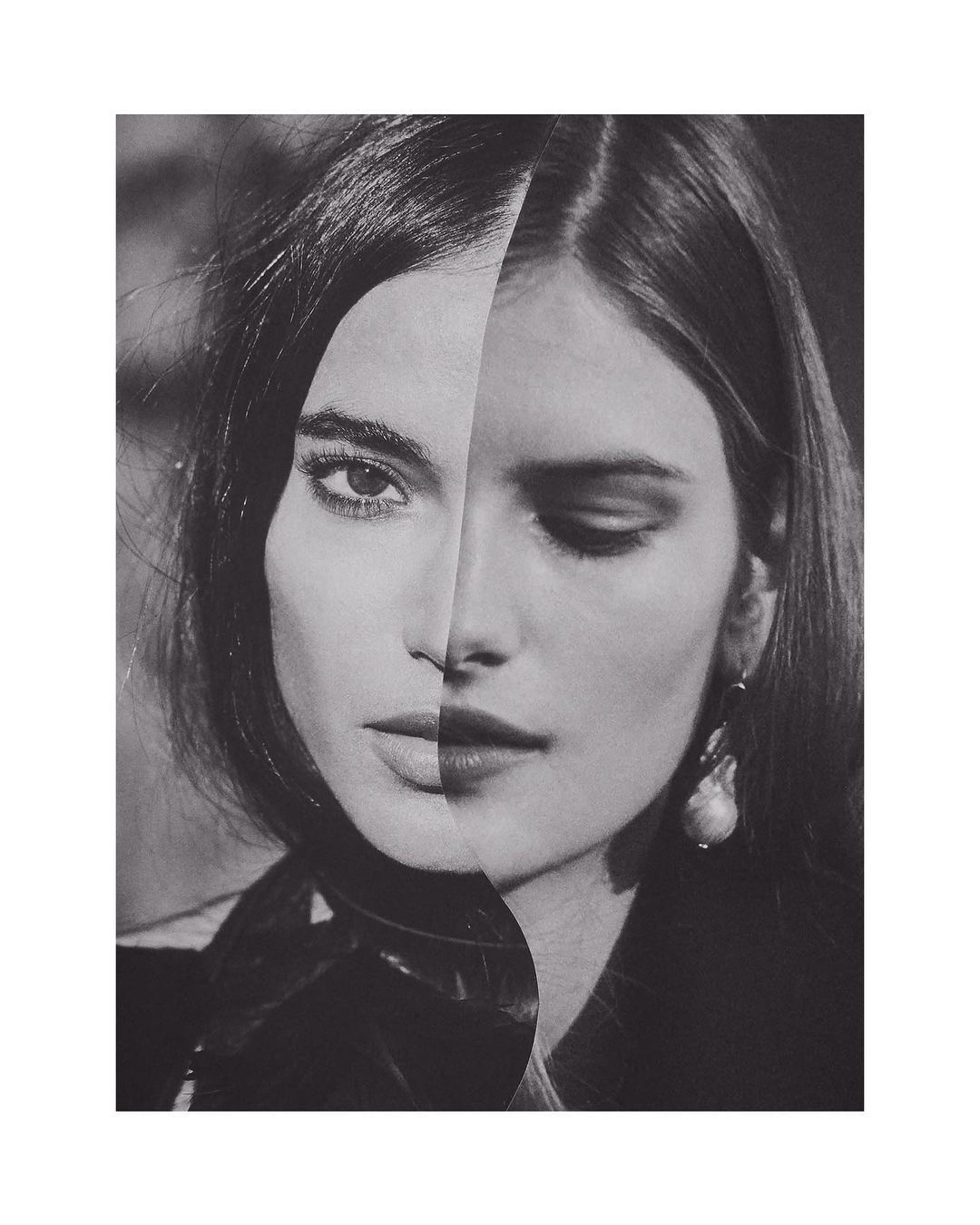 Monochromatic portrait of a split-face woman, one side with closed eyes and pearl earring, the other side with open eyes, stylish hair.