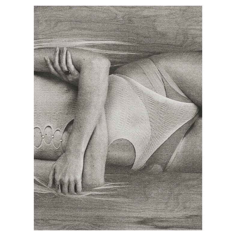 Graphite drawing depicting a woman lying down, wearing a garment, with a textured background and a focus on subtle shading.