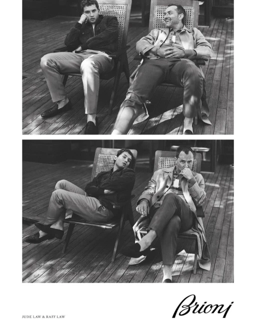 Black and white studio shot of Jude Law and Raff Law sitting in chairs, wearing casual clothes, and posing for a Brioni ad.