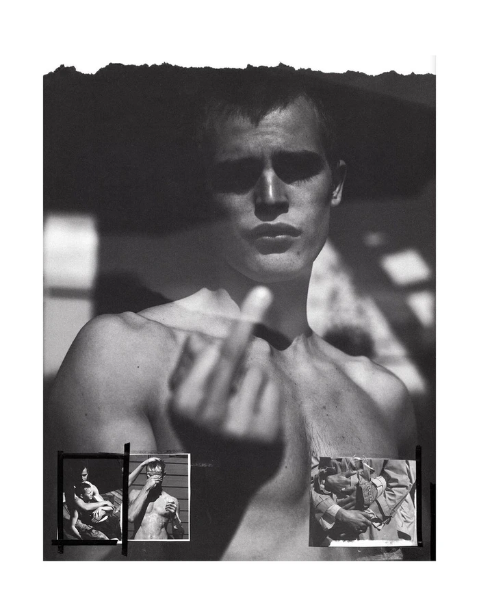 Black and white portrait of a shirtless man gesturing towards the camera by Annemarieke Van Drimmelen