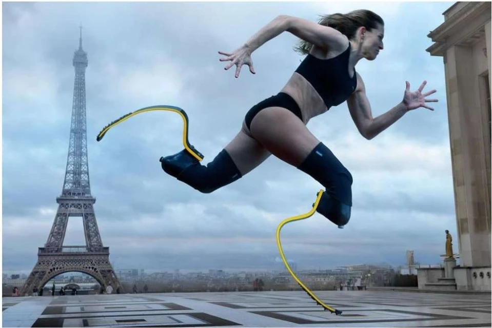 Athletic woman with prosthetic legs in motion, running in an urban setting with the Eiffel Tower in the background.