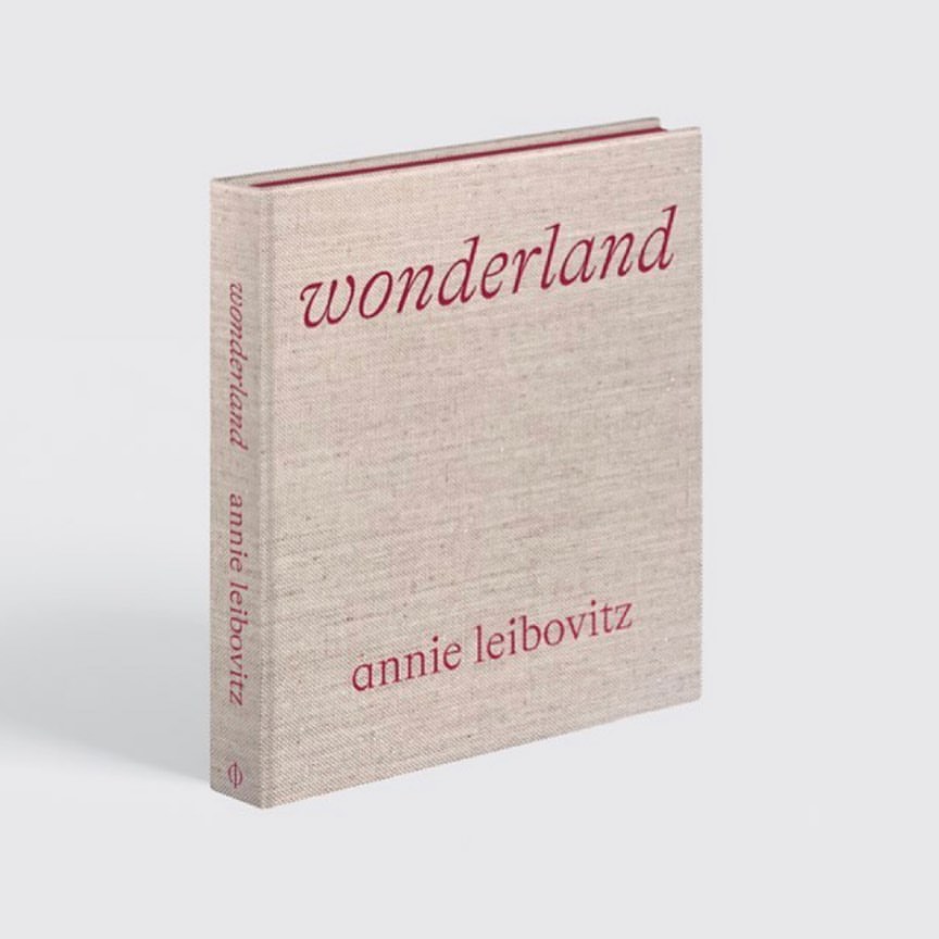 Studio shot of the photography book 'Wonderland' by Annie Leibovitz, featuring a light tan cover with red title text, set against a neutral background.