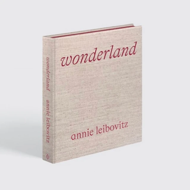 Studio shot of the photography book 'Wonderland' by Annie Leibovitz, featuring a light tan cover with red title text, set against a neutral background.