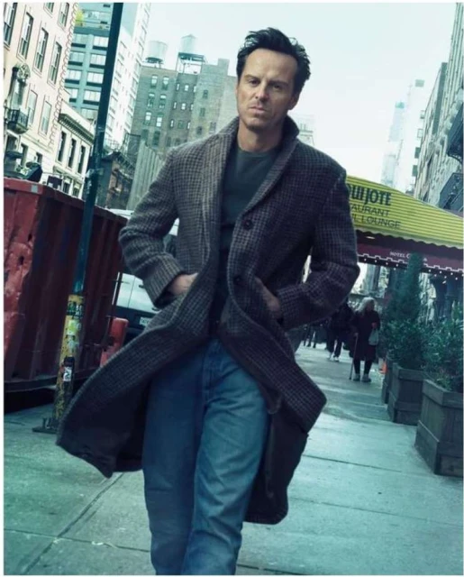 Man in tweed coat walks on a city street, hands in pockets, buildings and street in the background, medium shot, lifestyle.