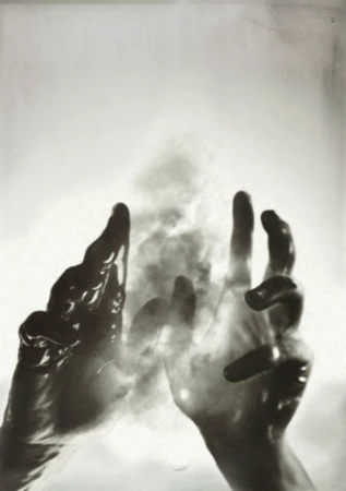 Monochrome artwork showing two hands reaching upward through swirling smoke and mist against a pale background.