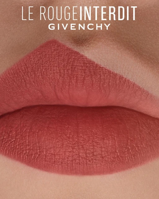 Close-up studio shot of lips with lipstick in a neutral, rosy-peach tone, with brand text "Le Rouge Interdit" and "Givenchy".