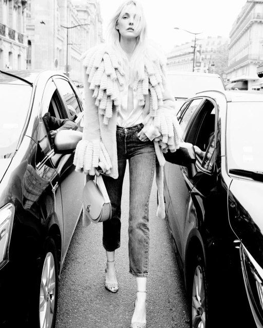 Portrait of Anthony Seklaoui, a man with a short beard, wearing glasses, a black sweater, and a jacket, against a dark background.