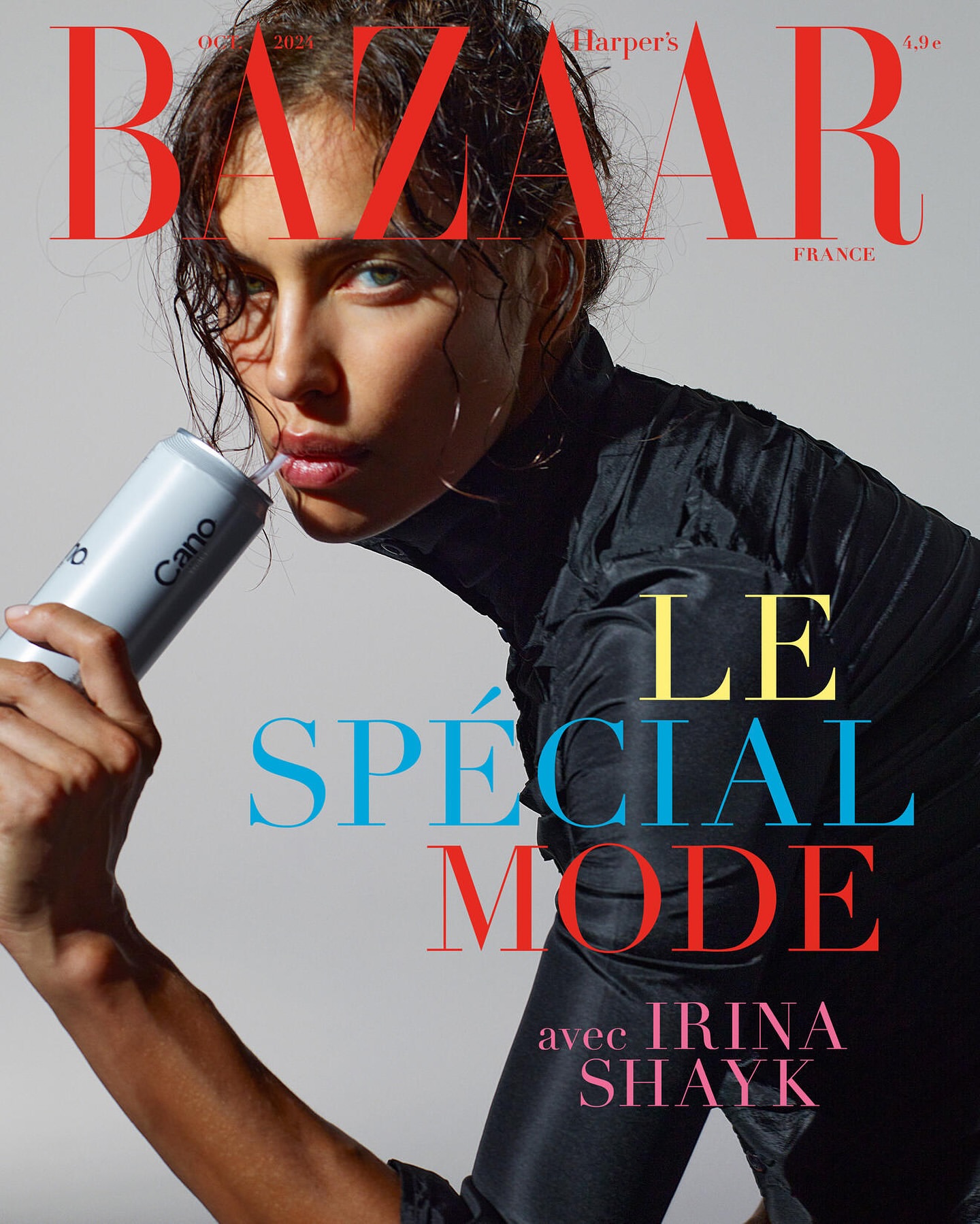 Magazine cover featuring Irina Shayk in black top, holding a Cano water bottle, against a light gray background with bold text.