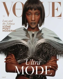 Model with short black bob and septum piercing wearing a metallic silver structured top on Vogue France cover