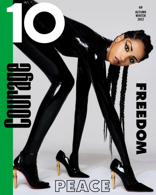Magazine cover featuring a female model in a shiny black bodysuit and high heels, showcasing a bold and modern fashion statement.