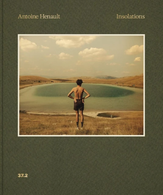 Person stands at the edge of a grassy hill looking at a lake surrounded by a field under a cloudy sky in a book cover image.