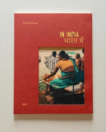 Book cover featuring a photograph of a woman in India selling goods, with the title 'In India' in English and another language.