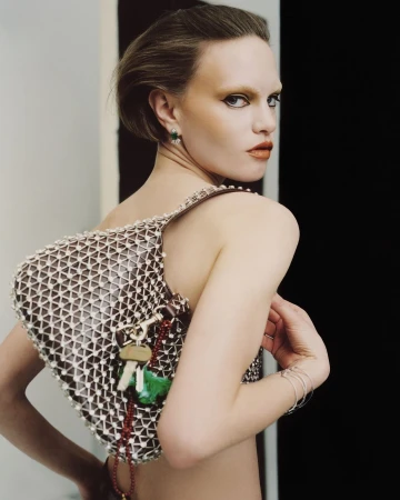 Model wearing a beaded mesh bag with hanging keys and bracelets, captured in a portrait by Antonio Dicorato in Paris.