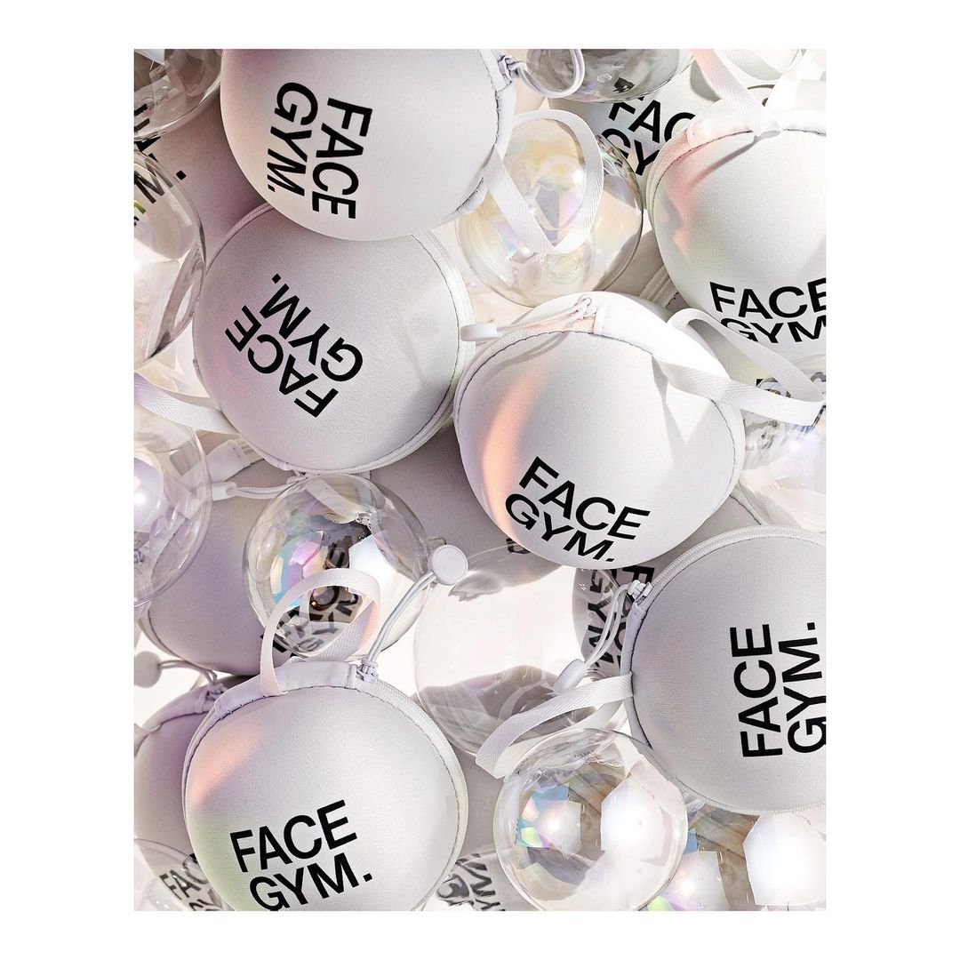 Close-up shot of multiple white and clear ornamental balls with black brand-name text. Spherical shapes, holiday concepts, decorative elements.