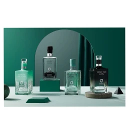 Four gin bottles with labels reading Three Seasons, Anty Gin, Japanese Gin, and Truffle Gin displayed on pedestals.
