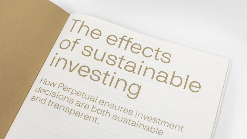 An open notebook with cream-colored paper displaying brown typography reading The effects of sustainable investing, set against white.