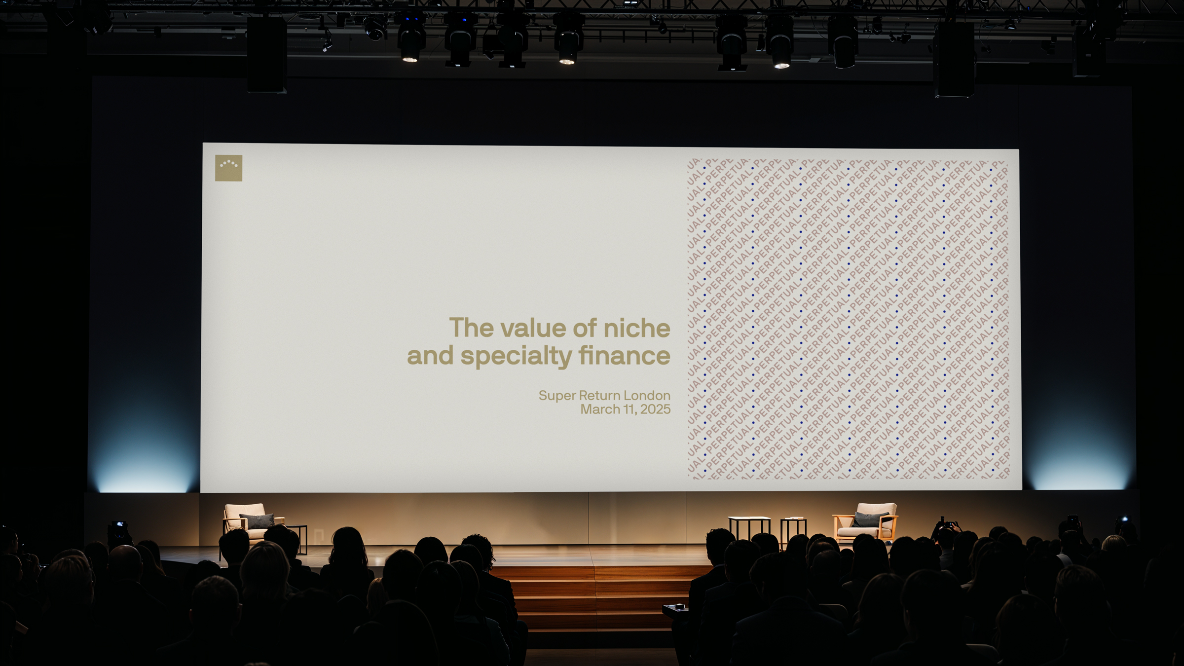 Wide conference stage with a large presentation screen reading The value of niche and specialty finance before a seated audience