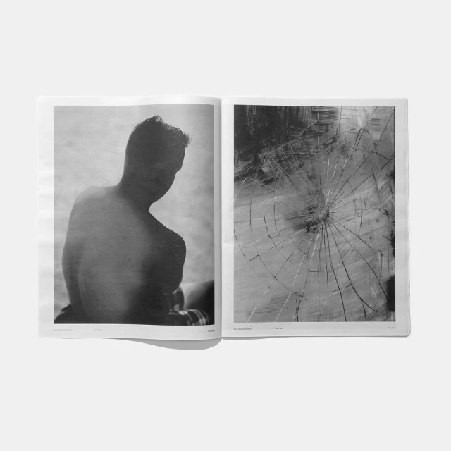 Two pages of a monochrome art magazine featuring a torso of a man on the left and abstract broken glass artwork on the right.