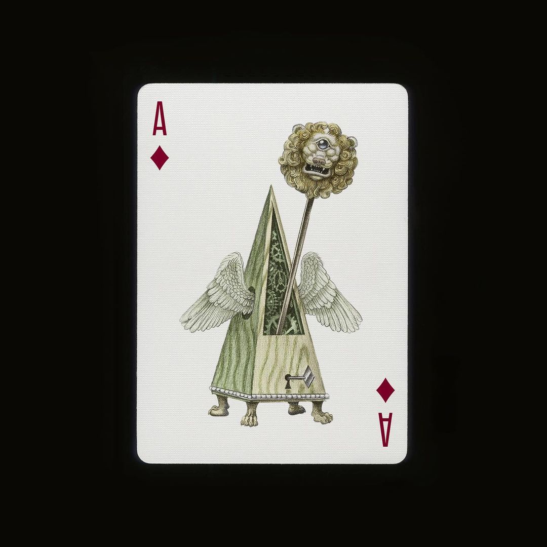 Surreal playing card illustration features a pyramid on animal feet with wings, topped by a lion's head scepter on a black background.