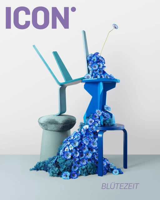 Cover art for ICON magazine featuring an upside down chair balanced on a stool, blue flowers cascading down the furniture.