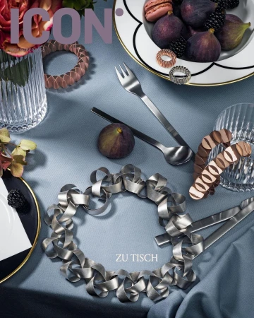 Still life of figs, blackberries, silverware, and table decorations on a light blue tablecloth, styled for an ICON magazine cover.