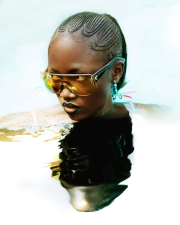 Black woman wearing tinted yellow shield sunglasses and dark lipstick partially submerged in water by Arnaud Lajeunie