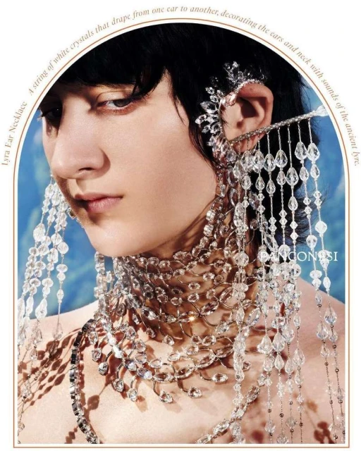 Close-up of a model wearing an elaborate crystal ear cuff and necklaces, showcasing a high-fashion beauty look with artistic jewelry.