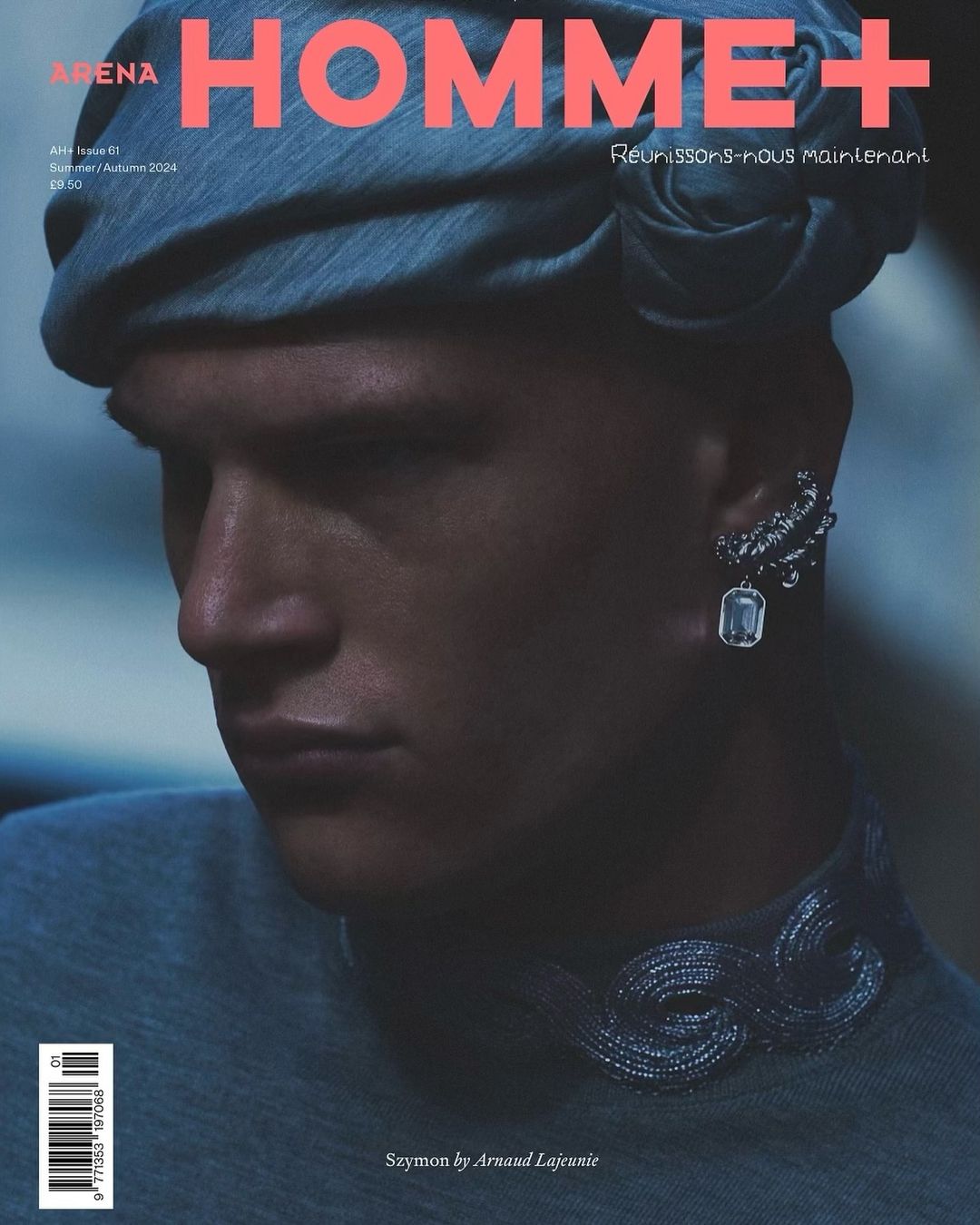 Arena Homme+ magazine cover featuring a male fashion model in a blue head wrap and ornate jewelry against a dark backdrop.
