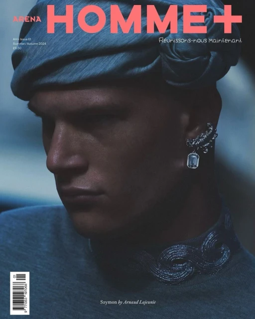 Arena Homme+ magazine cover featuring a male fashion model in a blue head wrap and ornate jewelry against a dark backdrop.