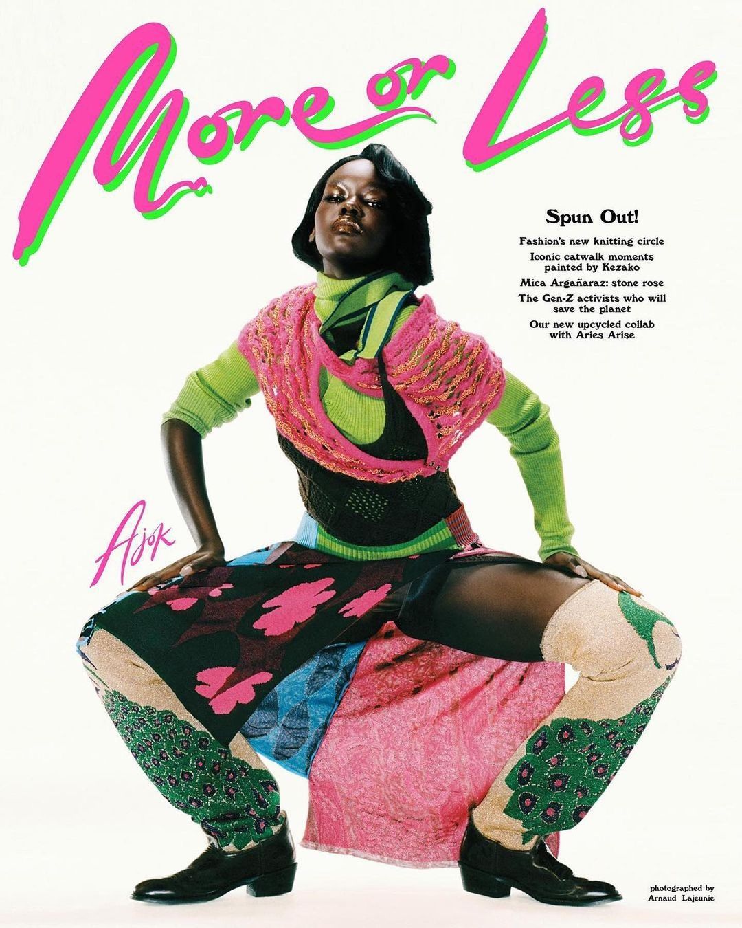 Dark-skinned woman in a brightly colored knit outfit strikes a dynamic pose in a fashion editorial; studio shot with graphic magazine text.