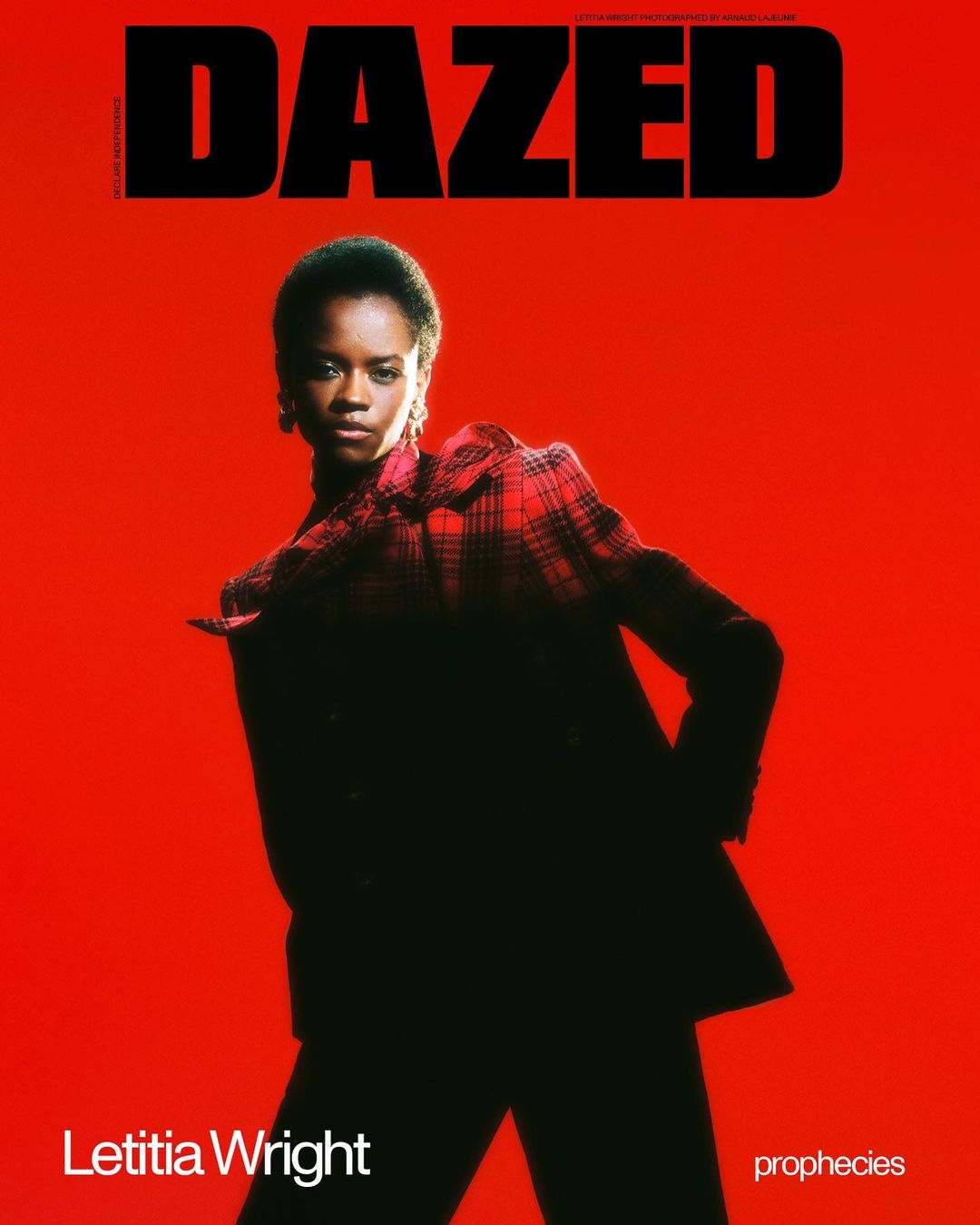 Magazine cover featuring Letitia Wright in a plaid suit against a vibrant red background with the 'Dazed' logo prominently displayed.