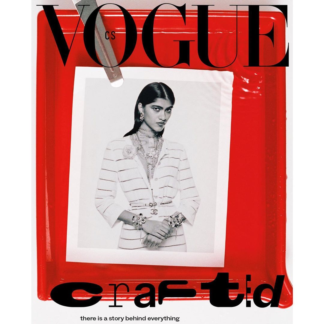 Vogue cover featuring a woman wearing a white striped suit and jewelry, set against a red frame with 'crafted' text, shot in a photo studio.
