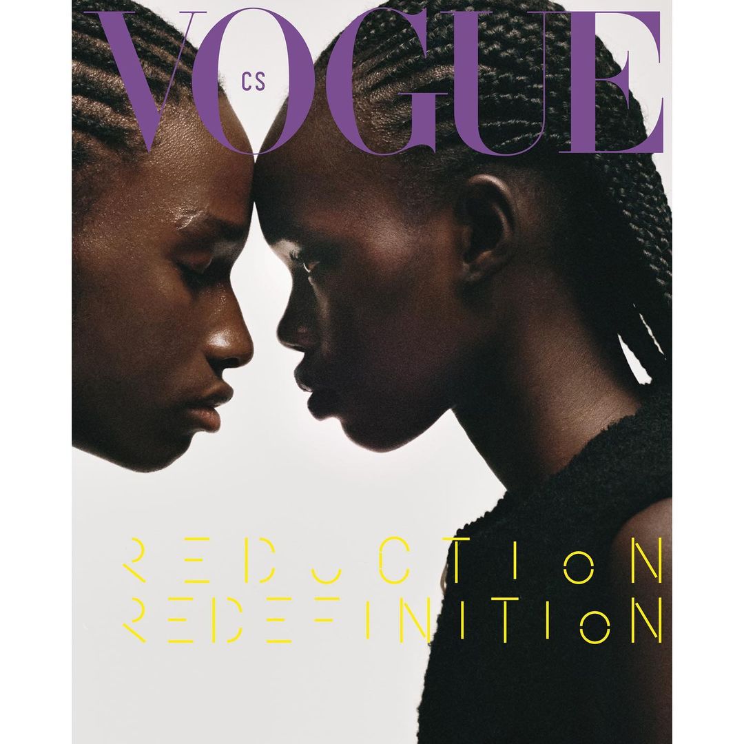 Vogue cover featuring two Black women with braided hair, close together against a white background with yellow text, fashion beauty portrait.